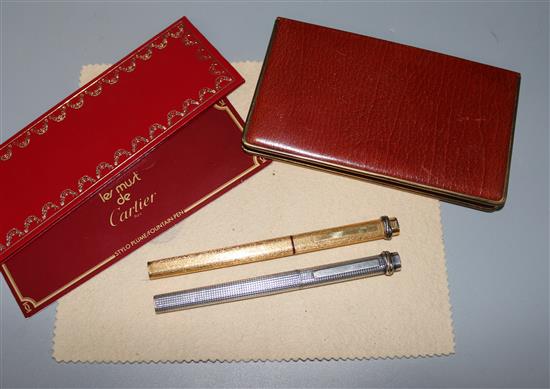 A Cartier cigarette case and two pencils
